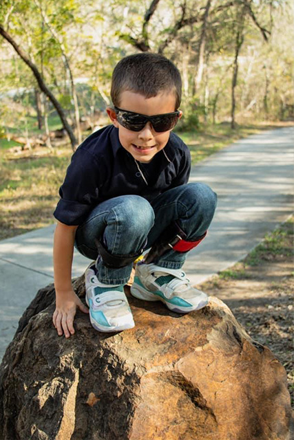 child standing on a rock